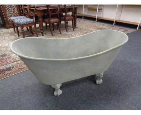 A metal planter in the form of a Victorian roll top bath 
