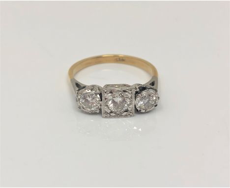 An 18ct gold three stone diamond ring, the three brilliant cut stones approximately 1ct, shank stamped 18ct, size O.