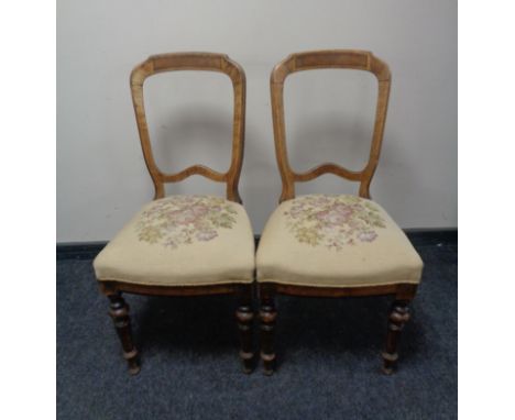 A pair of antique dining chairs with a floral tapestry upholstered seat 