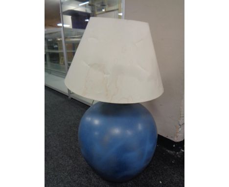 A painted glass carbouy converted to a table lamp 