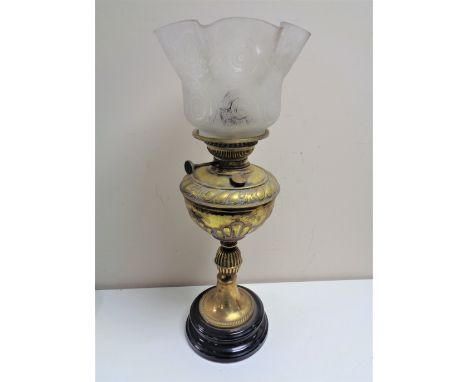 An Edwardian brass oil lamp with glass shade 