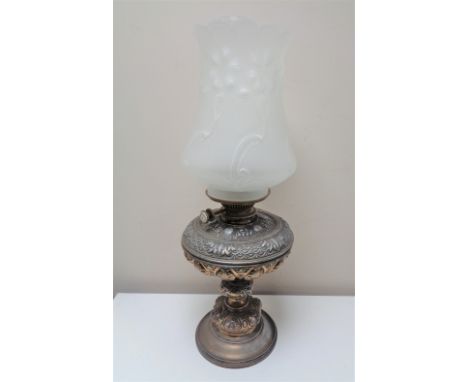 A Victorian metal oil lamp with glass shade 