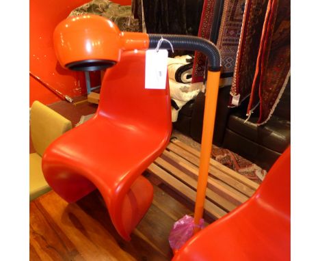 A retro floor standing lamp on adjustable supports