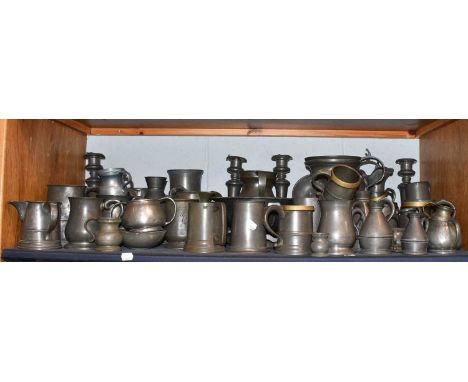 A large collection of 18th century and later pewter items including candlesticks, tankards, jugs and measures etc, touch mark