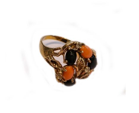 An abstract coral and jet ring, stamped '14K', finger size P1/2Condition report: Gross weight 8.1 grams.