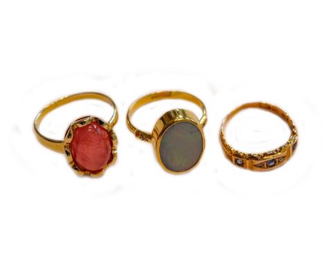 A 15 carat gold sapphire and diamond ring, finger size L1/2; an opal doublet ring, stamped '18K', finger size O; and a quartz