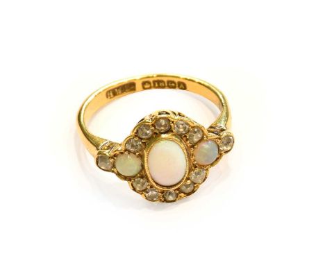 An 18 carat gold opal and diamond cluister ring, finger size OCondition report: Gross weight 4.7 grams.