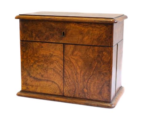 A Victorian figured walnut decanter box fitted with a pair of glass decanters and stoppers, a pair of sherry glasses, a silve