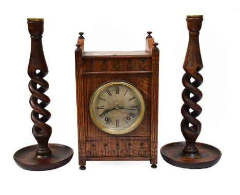 An early 20th Century Winterhalder &amp; Hofmeier oak table clock, a pair of turned candlesticks, an oak candle sconce and a 