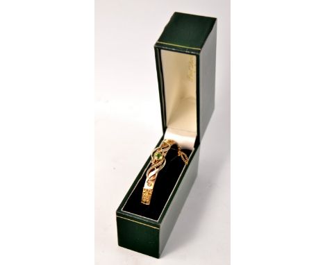 Edwardian 9ct gold dated 1906 pearl and tourmaline bangle in half scrolling designD: 6.5cm approx Gross weight approx 10.4g