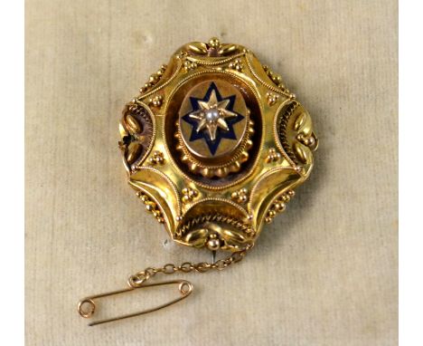 Victorian yellow metal mourning brooch with small seed pearl set in a star design highlighted with enamel, safety chain attac