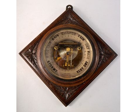 A nice example of an oak  aneroid barometer, maker E LENNIE Edinburgh,  oak carved in a floral and leaf pattern, in a diamond