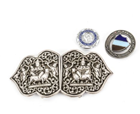 A vintage Indian silver nurse's belt buckle, together with two nurse's badges (4) 