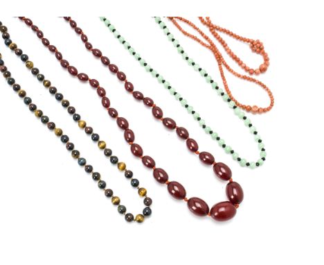 A knotted string of cherry amber style oval beads, 62g, together with two coral necklaces, a tigers eye necklace and a simula