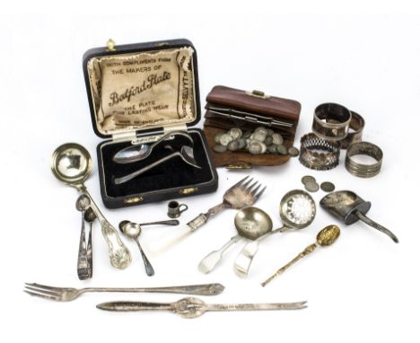 A small collection of silver and silver plate, including a silver napkin ring and gilt spoon, and other spoons, along with a 