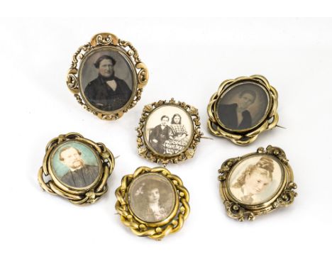 A collection of ambrotype and painted photograph framed brooches, all Victorian with gilt metal surrounds and pin backs, one 