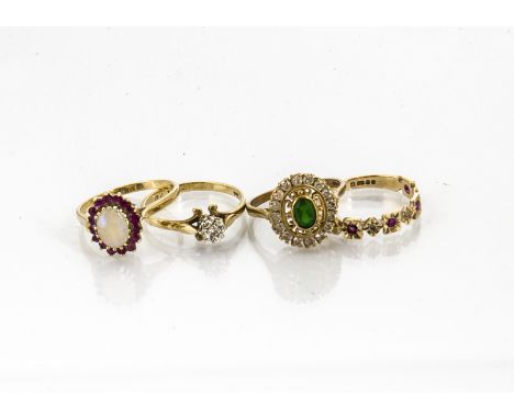 Four gem set gold rings, including an opal and ruby example, ruby and diamond, illusion diamond and another, total weight 9.8
