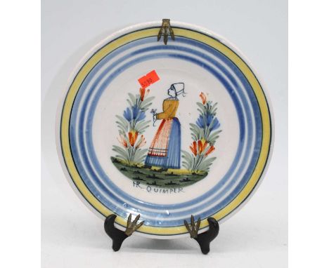 A Quimper plate, decorated with girl amongst flowers, dia. 23.5cm