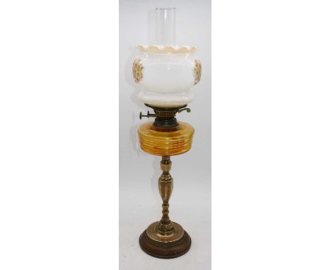 A 19th century brass oil lamp, having milk glass shade and amber glass font, overall h.67cm 
