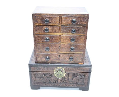 An oak table-top chest, containing an arrangement of eight drawers, w.25cm; together with an Eastern carved box, w.32cm (2)