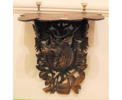 A Black Forest carved wall bracket, in the form of a stag amongst foliage, height 48cm