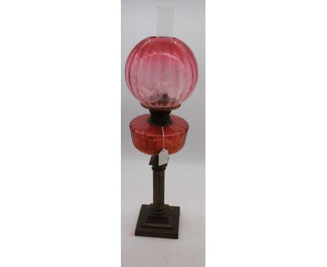 A 19th century brass oil lamp, having acid etched cranberry glass shade and cranberry font, h.67cmextra pics.No chips, cracks
