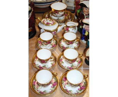 A Royal Chelsea Golden Rose pattern six place tea serviceVery light wear to gilding.Teapot has chip to spout and underside of