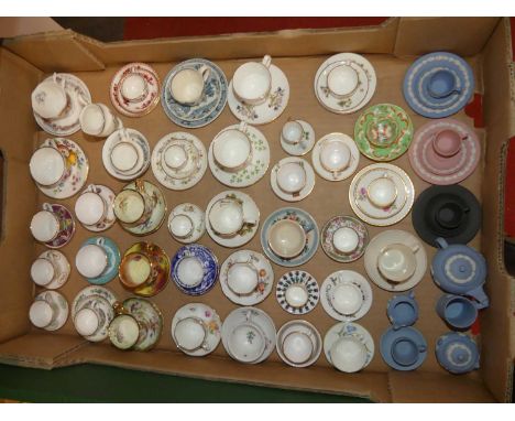 A collection of miniature teacups and saucers to include Crown Derby and Wedgwood