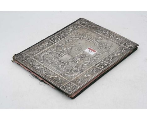 A late Victorian leather blotter, the white metal cover embossed with the word Punch above a figure of Mr Punch seated before