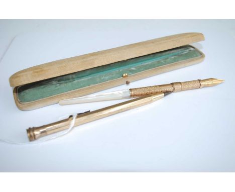 A W Faber of New York fountain pen, having a propelling 14ct gold nib, with an engine turned gilt metal sleeve and mother of 