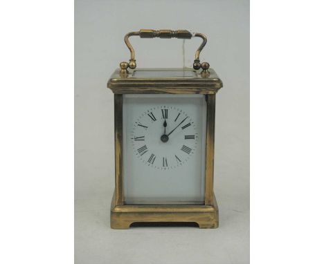 An early 20th century lacquered brass cased carriage clock, having enamelled dial with Roman numerals, visible platform lever