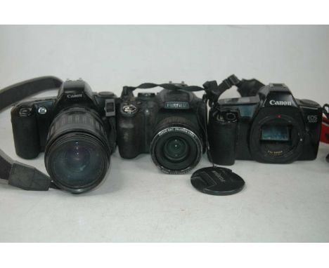 A Fujifilm Finepix SL camera, with Super EBC Fuginon lens; together with a Canon E0 5000 camera (lacking lens); a Canon EO 50