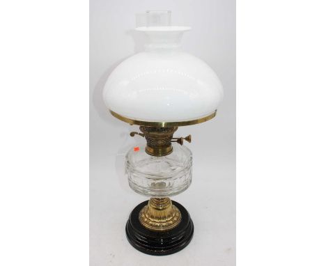 A 19th century oil lamp, having milk glass shade and faceted clear glass font, overall h.55cm 