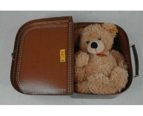 A Steiff beige teddy-bear, in original holiday suitcase box with tag, h.27cm 