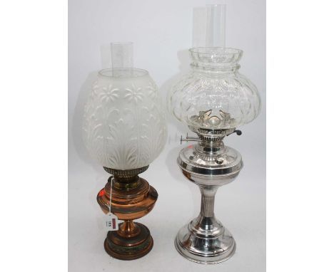 A copper oil lamp, having a floral moulded and frosted glass shade, overall h.49cm; together with one other (2)