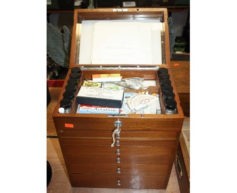 A 20th century teak dentist's chest, containing various implements, w.33cmThere are various dentists implements in drawersH –