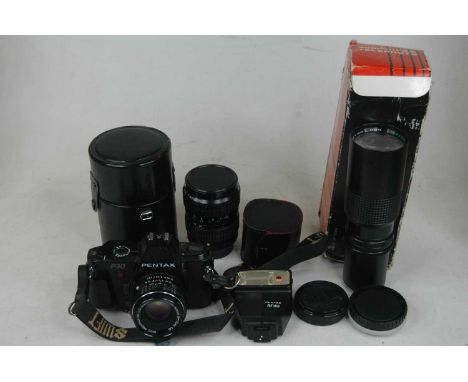 A Pentax P30 camera with accessories and spare lenses, to include a TAKUMARA zoom lens 28x18mm, and a 300mm telephoto lens 