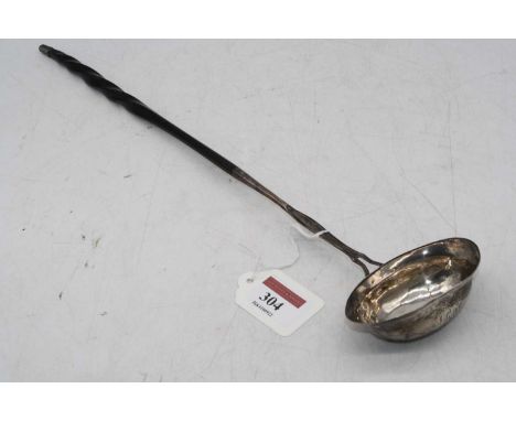An early 19th century continental white metal toddy ladle, having an oval shaped bowl on turned whalebone handle, length 36cm