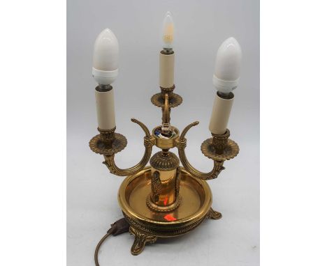 A 20th century brass three-branch table lamp, having toleware type shade, h.40cm (including fittings)