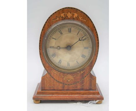 A 20th century mahogany cased mantel clock, the dial showing Roman numerals, standing upon four brass bun feet, height 18cm
