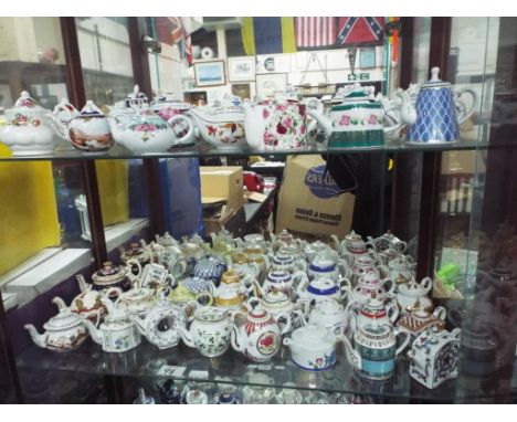 In excess of 60 pieces of ceramic ornamental ware, predominantly novelty teapots (over three shelves)