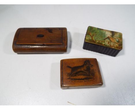 A papier mache snuff box, the hinged lid decorated with a water mill also included in the lot are two further wooden hinge li