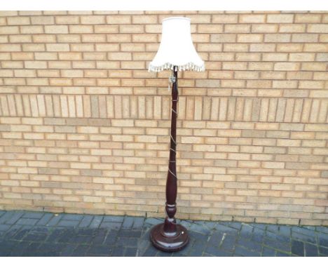 A good quality floor standing lamp with cream coloured shade