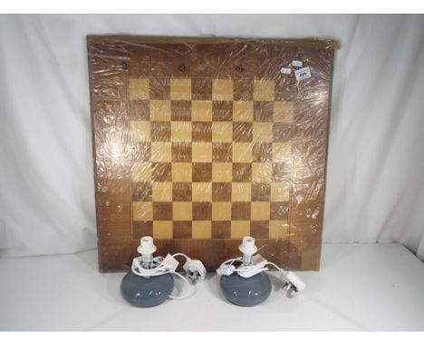 A good quality wooden inlaid chess board and a pair of ceramic grey pebble table lamps (all unused)