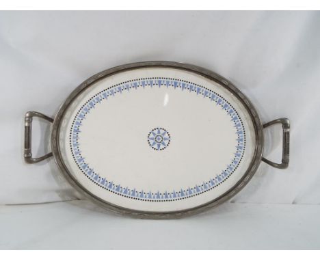 An oval metal and ceramic tray stamped W.M.F.