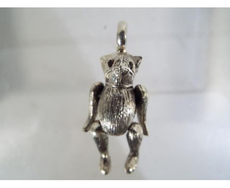 A silver pendant in the form of an articulated bear Est £45 - £65