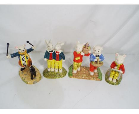 Royal Doulton - four Royal Doulton ceramic Rupert the Bear figurines to include Where Did You Get Such Fruit, Something to Dr