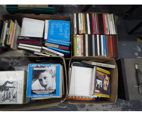 Four boxes containing a quantity of 8 mm film reels and similar and a Eumig P8 phonomatic projector (5)