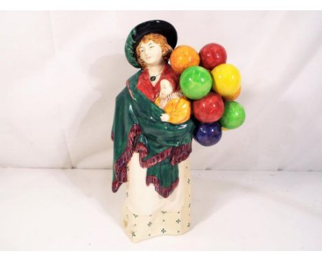 A Royal Doulton ceramic figurine entitled The Balloon Seller, HN583, approximate height 22cm