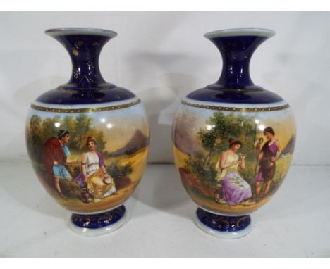 A pair of Royal Vienna style ceramic vases decorated with figural couples in a landscape scene on a blue ground with gilded d